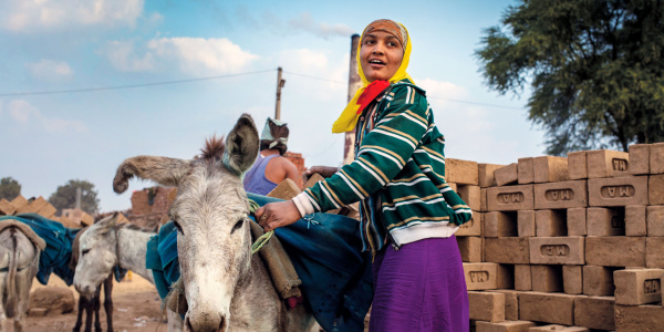 Brick kiln worker and donkey